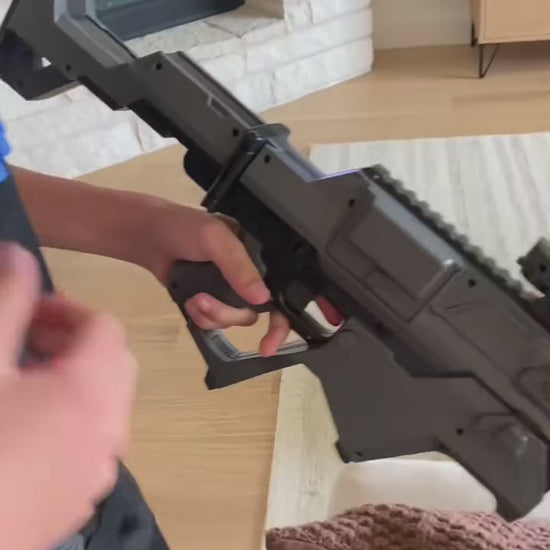 Loading a magazine into the Specter Auto Blaster with tactical vest